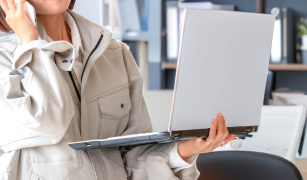 ノートPCの画面を見ながら打合せをする女性のイメージ画像